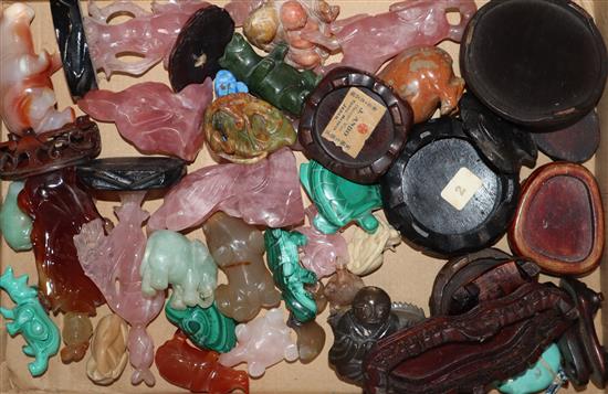 A collection of rose quartz and malachite animals and figures, wood stands (27)